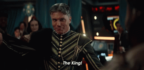 A Man Sitting On A Throne With The Words " The King " Written On It GIF