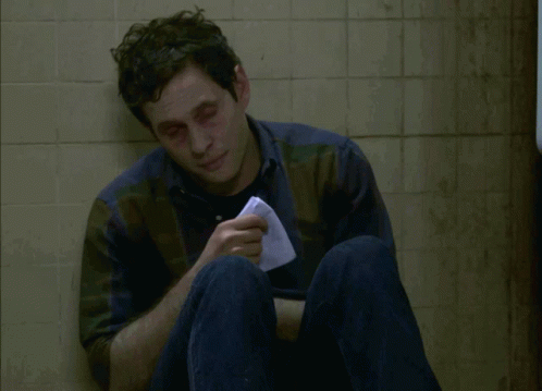 A Man Sitting On The Floor With A Napkin In His Hand And The Words I Think I Might Be Coming Down GIF