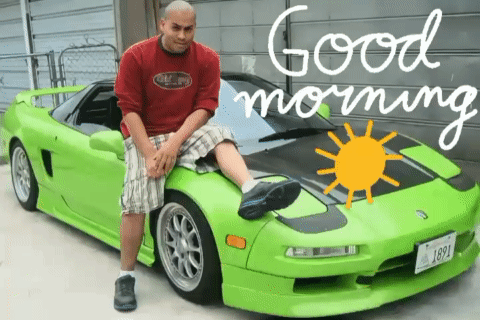 A Man Sitting On The Hood Of A Green Sports Car With The Words Good Morning Written On The Bottom GIF