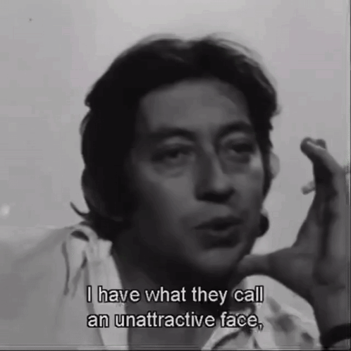 A Man Smoking A Cigarette And Saying " I Have What They Call An Unattractive Face " GIF