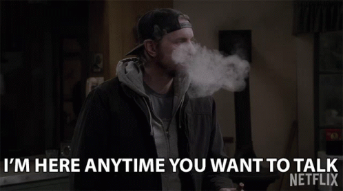a man smoking a cigarette and saying i 'm here anytime you want to talk