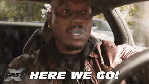 A Man Smoking A Cigarette In A Car With The Words Here We Go Below Him GIF