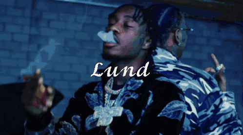 A Man Smoking A Cigarette With The Name Lund Written On The Bottom GIF