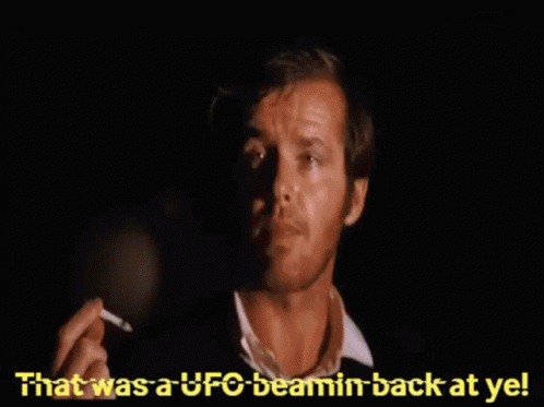A Man Smoking A Cigarette With The Words " That Was A Ufo Beamin Back At Ye " Behind Him GIF