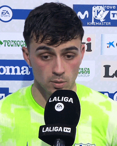 A Man Speaking Into A Laliga Tv Microphone While Wearing A Green Jersey GIF