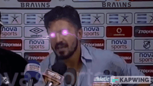A Man Speaking Into A Microphone In Front Of A Nova Sports Sign GIF