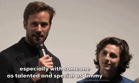 A Man Speaking Into A Microphone Next To Another Man With The Words " Especially With Someone As Talented And Special As GIF