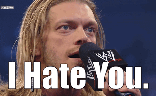 A Man Speaking Into A Microphone With The Words I Hate You Behind Him GIF