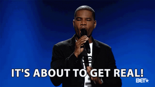A Man Speaking Into A Microphone With The Words It 'S About To Get Real Behind Him GIF