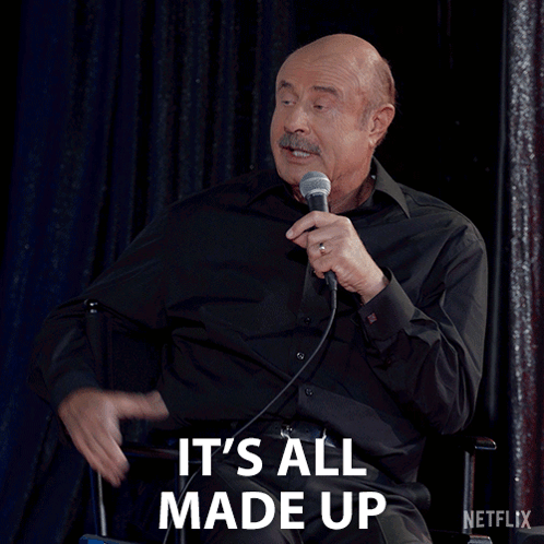 A Man Speaking Into A Microphone With The Words It 'S All Made Up Behind Him GIF