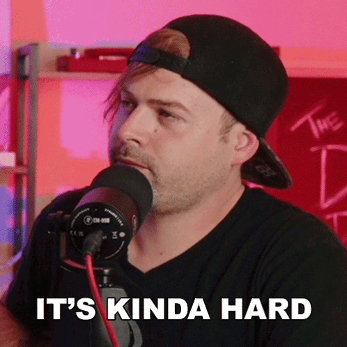 A Man Speaking Into A Microphone With The Words " It 'S Kinda Hard " Above Him GIF