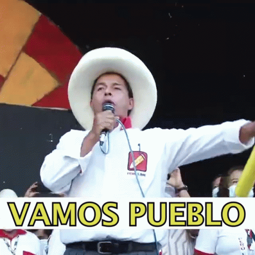 A Man Speaking Into A Microphone With The Words Vamos Pueblo Written Below Him GIF