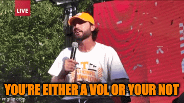 A Man Speaking Into A Microphone With The Words You 'Re Either A Vol Or Your Not Below Him GIF