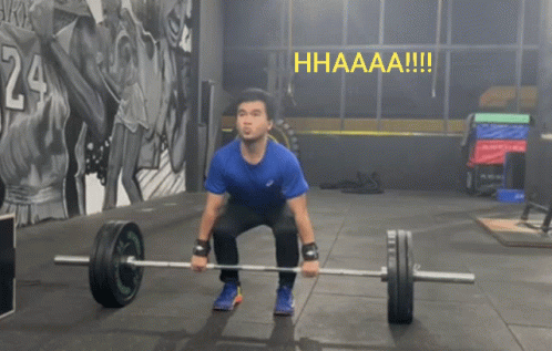 A Man Squatting Down Holding A Barbell With The Word Hhaaaa !!! Above Him GIF