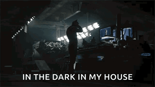 A Man Standing In A Dark Room With The Words In The Dark In My House Above Him GIF