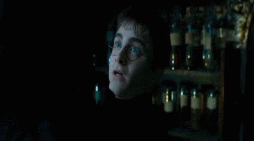 A Man Standing In A Dark Room With The Words " Ttene " On The Bottom GIF
