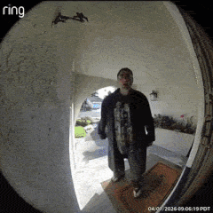 A Man Standing In A Doorway With A Ring Camera GIF