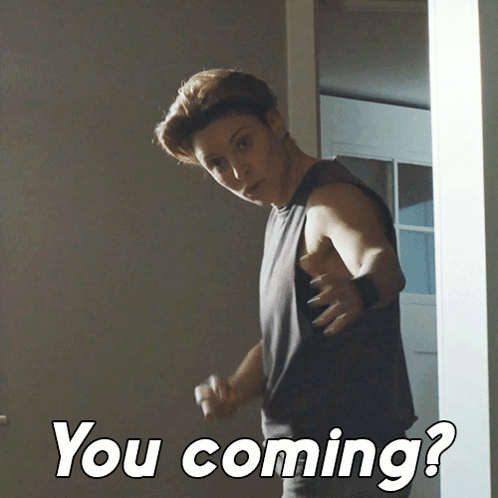 A Man Standing In A Doorway With The Words " You Coming " On The Bottom Right GIF
