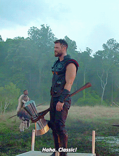 A Man Standing In A Field Holding An Axe And A Shield Says " Haha Classic ! " GIF
