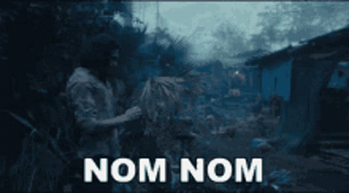 A Man Standing In A Field With The Words Nom Nom Written On The Screen GIF