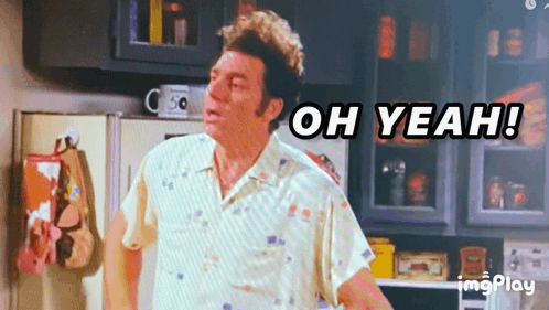 A Man Standing In A Kitchen With The Words Oh Yeah Behind Him GIF