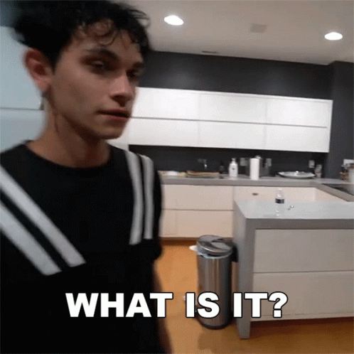 A Man Standing In A Kitchen With The Words What Is It Written On The Bottom GIF