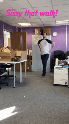 A Man Standing In A Room With The Words Sissy That Walk Written Above Him GIF