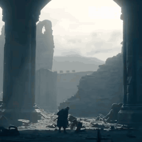 A Man Standing In A Ruined Building With A Sword GIF