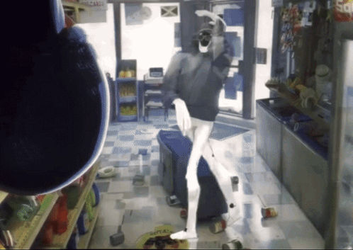Man Standing In Store With Candy Sign GIF