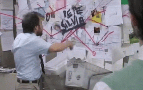 A Man Standing In Front Of A Bulletin Board That Says " Pepe Silvia " GIF