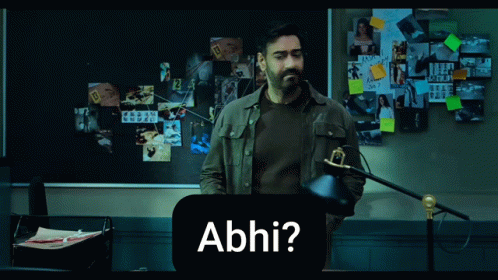 A Man Standing In Front Of A Bulletin Board With The Word Abhi On It GIF
