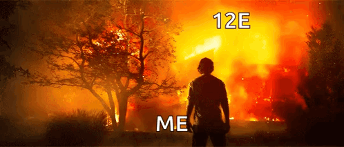 A Man Standing In Front Of A Burning Forest With The Words 12E Me Written Above Him GIF