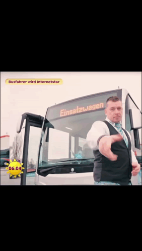 A Man Standing In Front Of A Bus That Says Einsatzwagen GIF
