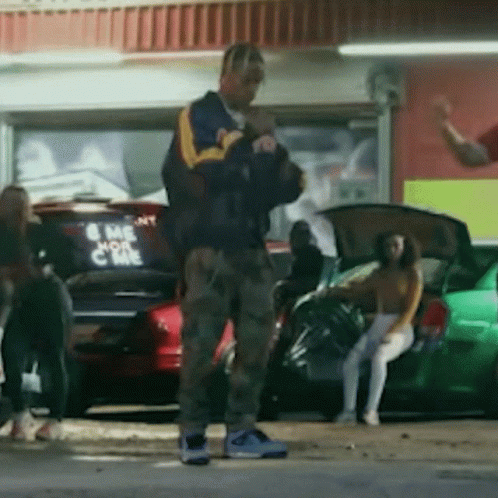 A Man Standing In Front Of A Car That Says Come On GIF