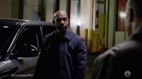 A Man Standing In Front Of A Car With #Chicagopd On The Bottom GIF