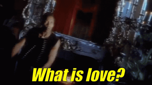 Man Standing In Front Of Coffin With What Is Love GIF
