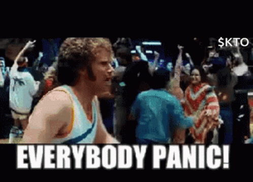 A Man Standing In Front Of A Crowd With The Words Everybody Panic GIF
