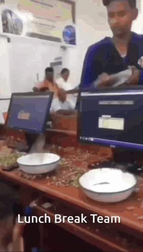 A Man Standing In Front Of A Desk With Bowls On It And The Words Lunch Break Team On The Bottom GIF