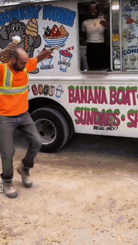 A Man Standing In Front Of A Donkey Kong Banana Boat Ice Cream Truck GIF