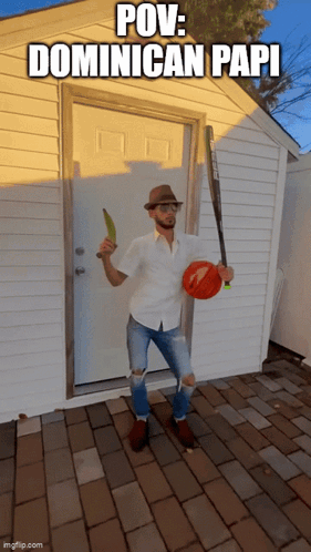 A Man Standing In Front Of A Door Holding A Baseball Bat And A Banana GIF