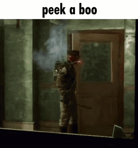 A Man Standing In Front Of A Door With The Words Peek A Boo On The Bottom GIF