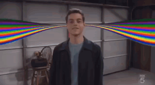 A Man Standing In Front Of A Garage Door With A Rainbow Coming Out Of His Ears . GIF