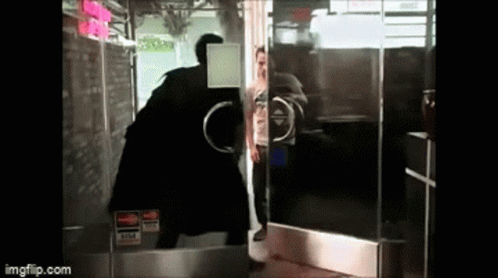 A Man Standing In Front Of A Glass Door With A Visa Sticker On It GIF