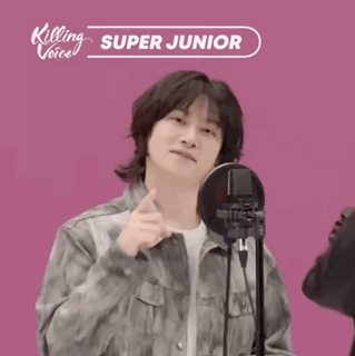 A Man Standing In Front Of A Microphone With Killing Voice Super Junior Written On It GIF