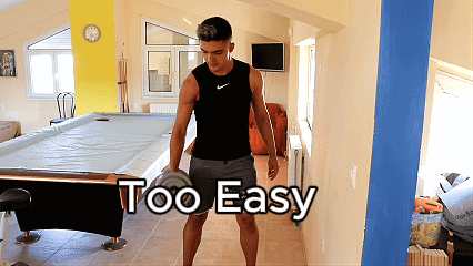 A Man Standing In Front Of A Pool Table With The Words Too Easy Written On The Wall GIF