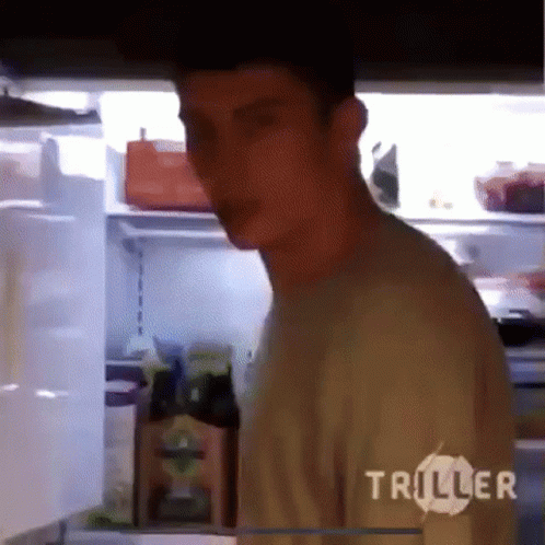 A Man Standing In Front Of A Refrigerator With The Word Triller On The Bottom GIF