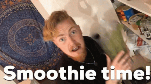A Man Standing In Front Of A Shelf With The Words Smoothie Time Written Below Him GIF