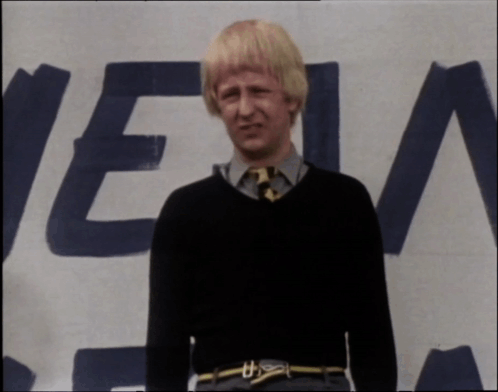 A Man Standing In Front Of A Sign That Says " Get It Right " GIF