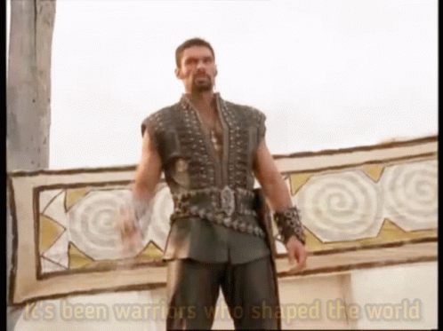 A Man Standing In Front Of A Sign That Says It 'S Been Warriors Who Shaped The World On It GIF