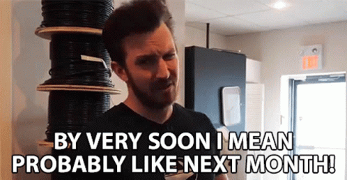 A Man Standing In Front Of A Stack Of Wires Says By Very Soon I Mean Probably Like Next Month ! GIF